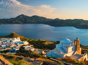 Greek Orthodox church in Plaka village on Milos island on sunset in Greece